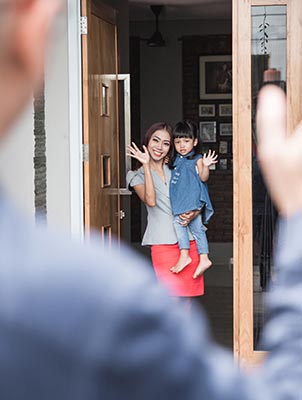 man wave goodbye to wife and children to leave for work